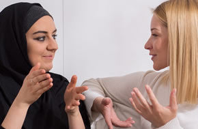 muslim woman and christian white woman talking